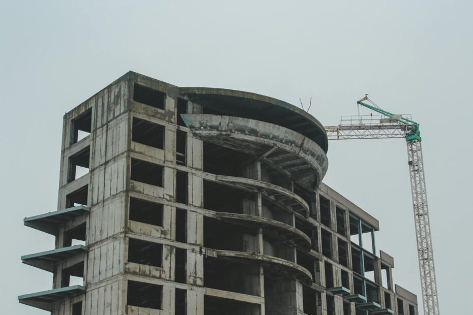 A high-rise building under construction with a crane, showcasing modern architecture in Constanța, Romania.